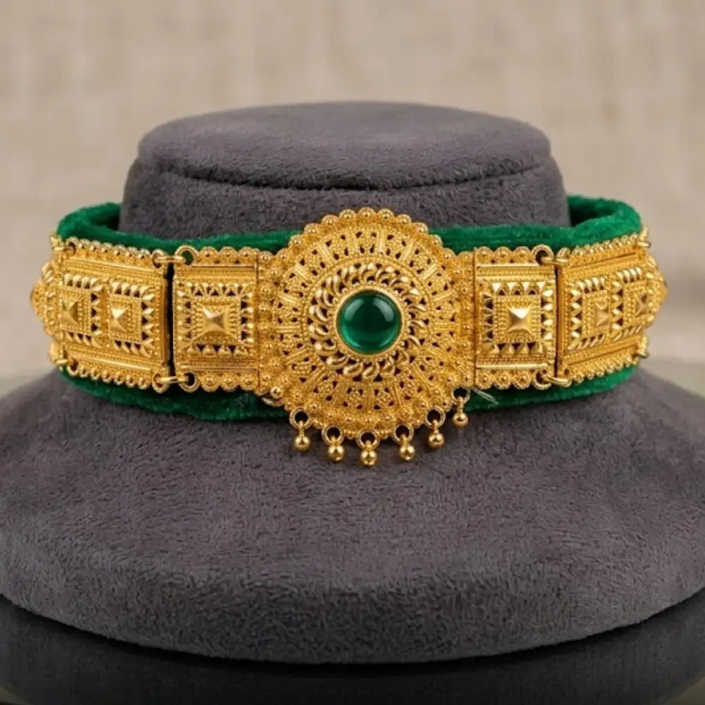 Gold green gemstone on a gray stand