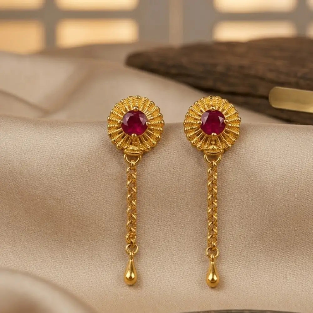 Gold earrings with red gemstones