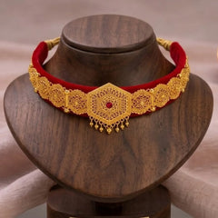 Gold galoband with red cord on a wooden stand