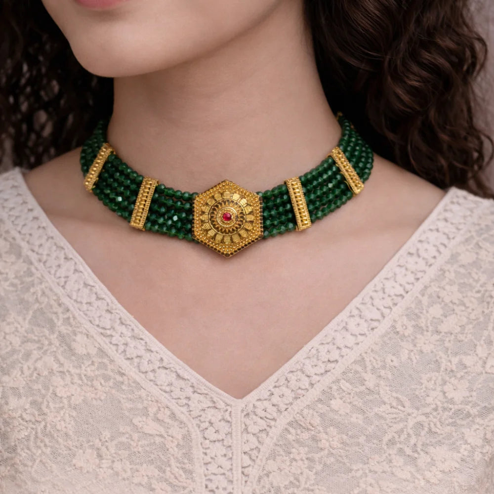 Green beaded choker with gold accents .