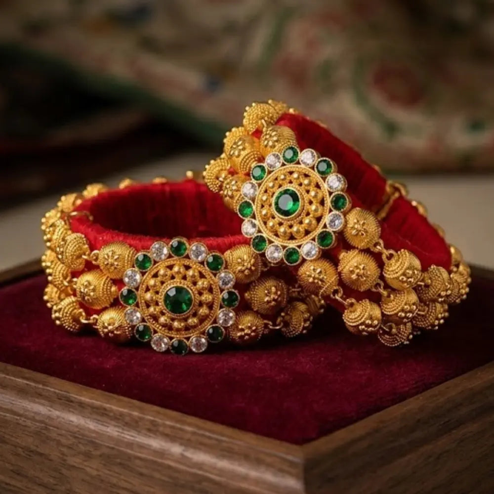 Gold red pauji with green gemstones 
